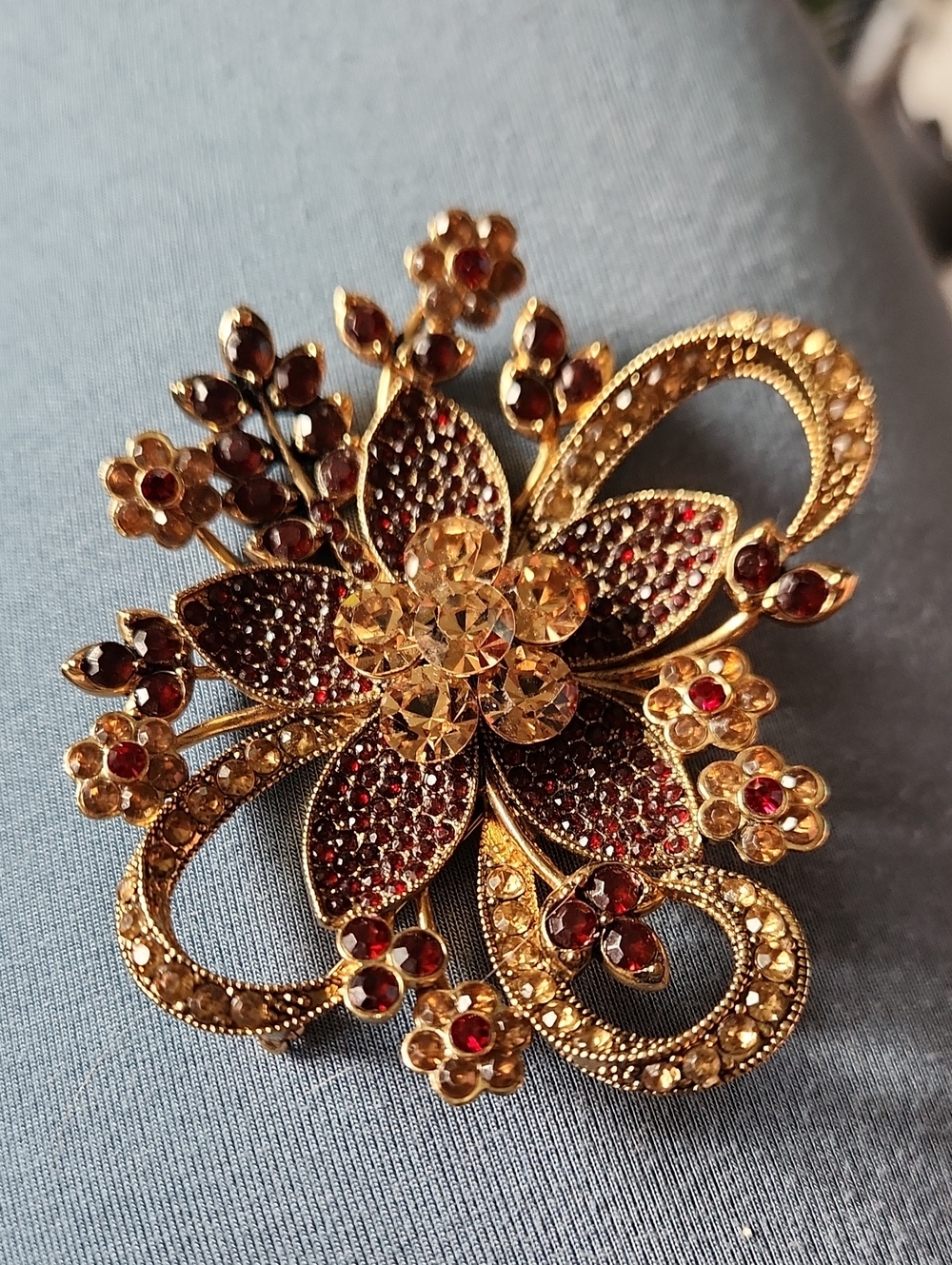 Gold-Tone Floral Crystal Brooch with Red and Champagne Stones